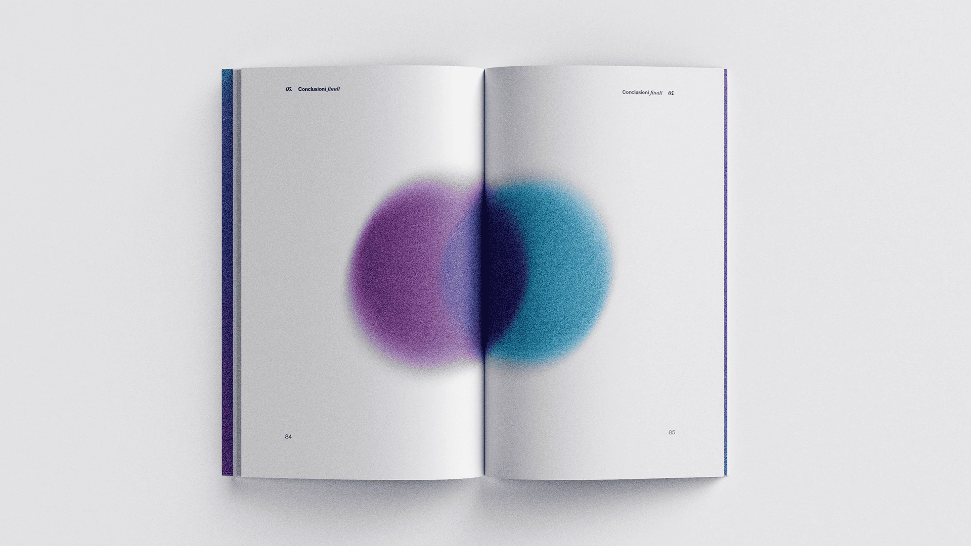 The book open on two overlapping circles, purple and blue.