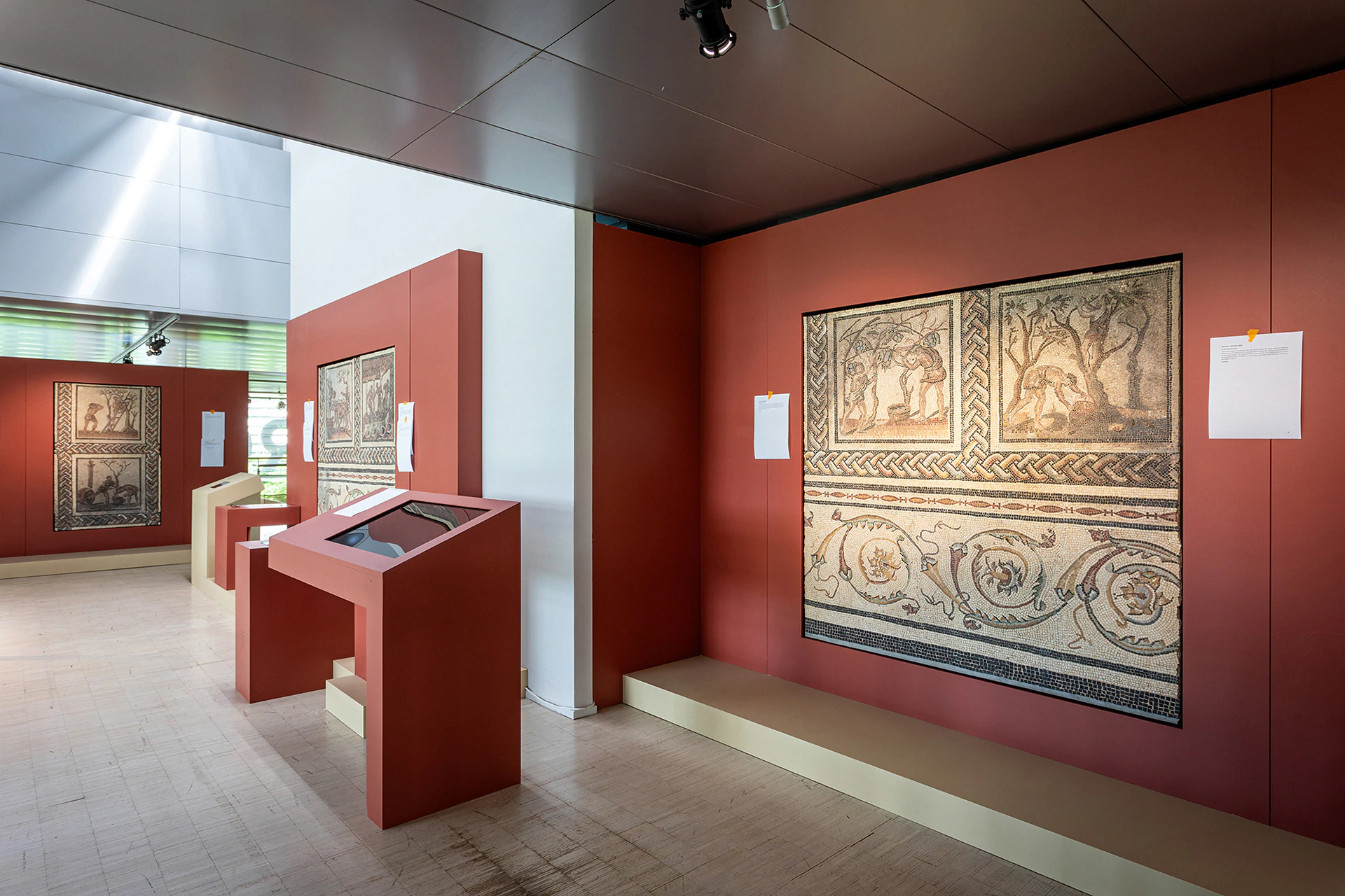A red room with a mosaic and an interactive station.