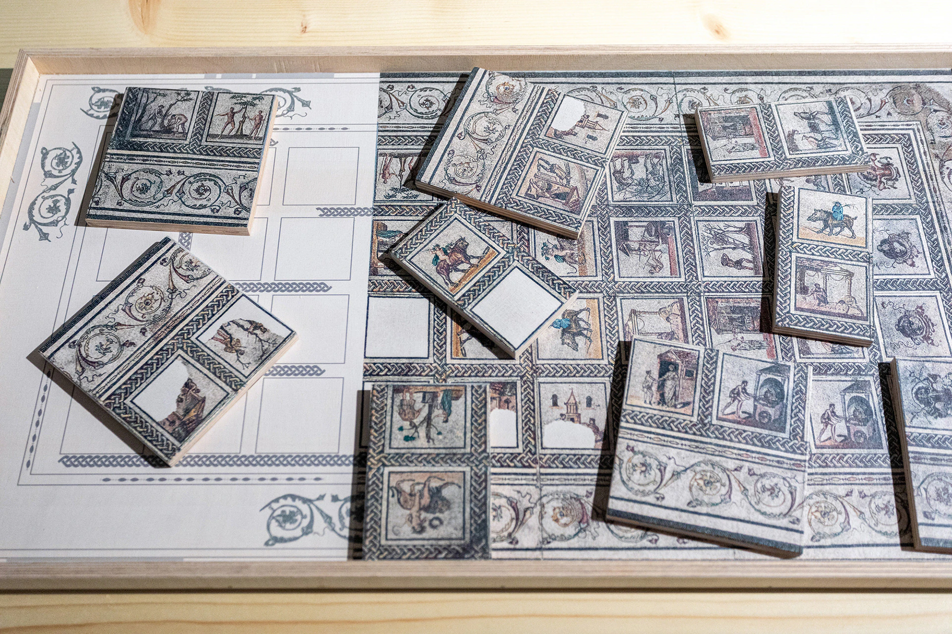 Tesserae and pieces of mosaic on a table, for visitors to analyse.