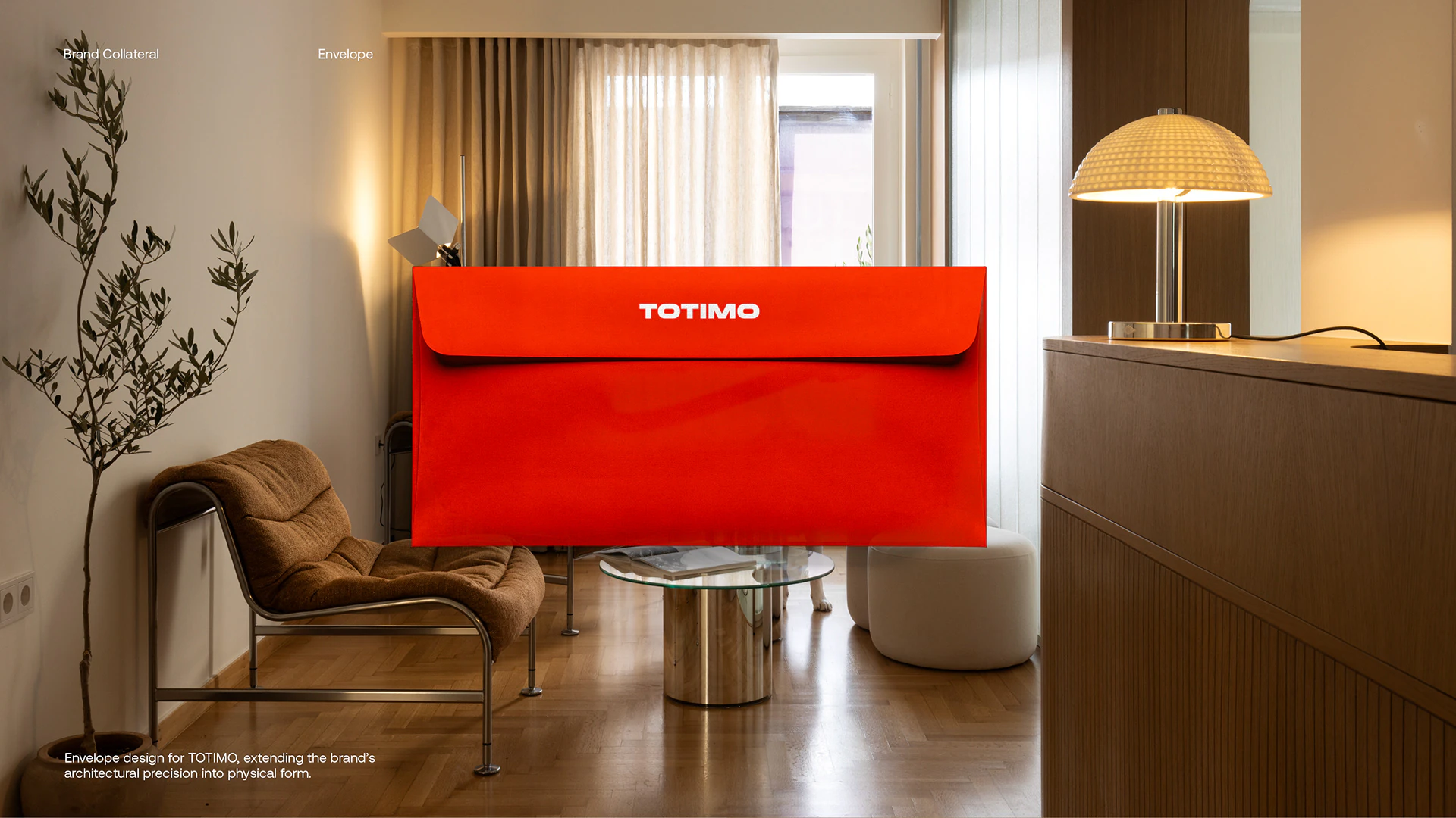 A red TOTIMO envelope on a low table in the showroom.